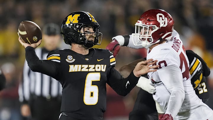 Nov 9, 2024; Columbia, Missouri, USA; Missouri Tigers quarterback Drew Pyne (6) throws a pass against Oklahoma Sooners defensive lineman Ethan Downs (40) during the second half at Faurot Field at Memorial Stadium. Mandatory Credit: Jay Biggerstaff-Imagn Images