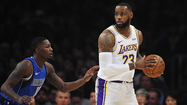 December 29, 2019; Los Angeles, California, USA; Los Angeles Lakers forward LeBron James (23) controls the ball against Dallas Mavericks forward Dorian Finney-Smith (10) during the first half at Staples Center. Mandatory Credit: Gary A. Vasquez-Imagn Images