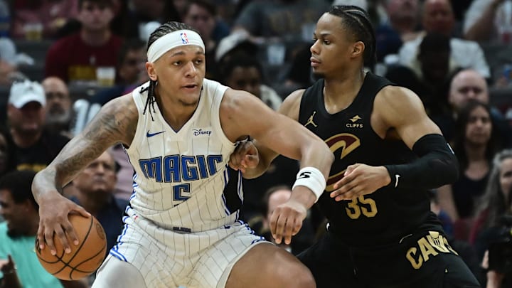 Apr 30, 2024; Cleveland, Ohio, USA; Cleveland Cavaliers forward Isaac Okoro (35) defends Orlando Magic forward Paolo Banchero (5) during the second half in game five of the first round for the 2024 NBA playoffs at Rocket Mortgage FieldHouse. Mandatory Credit: Ken Blaze-Imagn Images