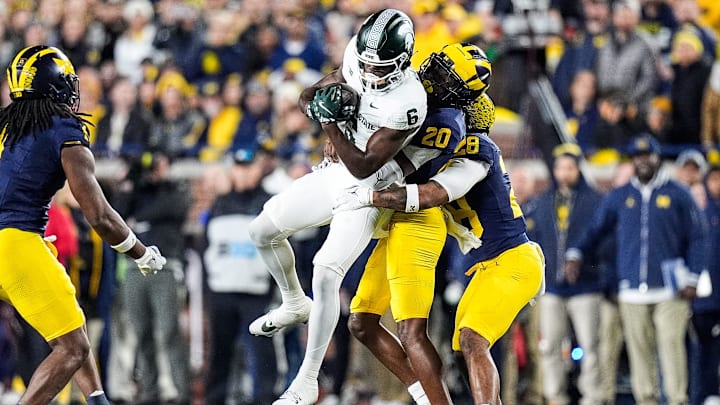 Michigan State wide receiver Nick Marsh (6) makes a catch against Michigan defensive back Jyaire Hill (20) and defensive back Quinten Johnson (28) during the first half at Michigan Stadium in Ann Arbor on Saturday, Oct. 26, 2024.