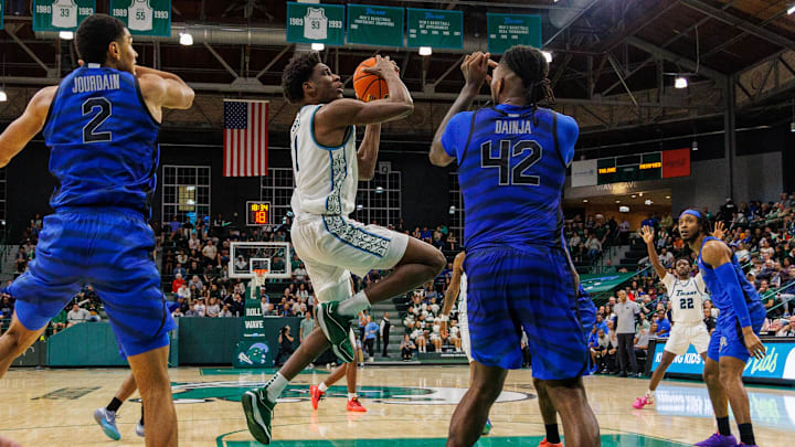 Jan 30, 2025; New Orleans, Louisiana, USA; Tulane Green Wave forward Kaleb Banks (1) drives to the basket against Memphis Tigers forward Dain Dainja (42) during the second half at Avron B. Fogelman Arena in Devlin Fieldhouse. Jan 30, 2025; New Orleans, Louisiana, USA; Tulane Green Wave forward Kaleb Banks (1) drives to the basket against Memphis Tigers forward Dain Dainja (42) during the second half at Avron B. Fogelman Arena in Devlin Fieldhouse.