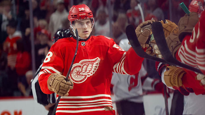 Apr 11, 2026; Detroit, Michigan, USA;  Detroit Red Wings center Emmitt Finnie (58) receives congratulations from teammates after scoring in the third period against the New Jersey Devils at Little Caesars Arena. Mandatory Credit: Rick Osentoski-Imagn Images