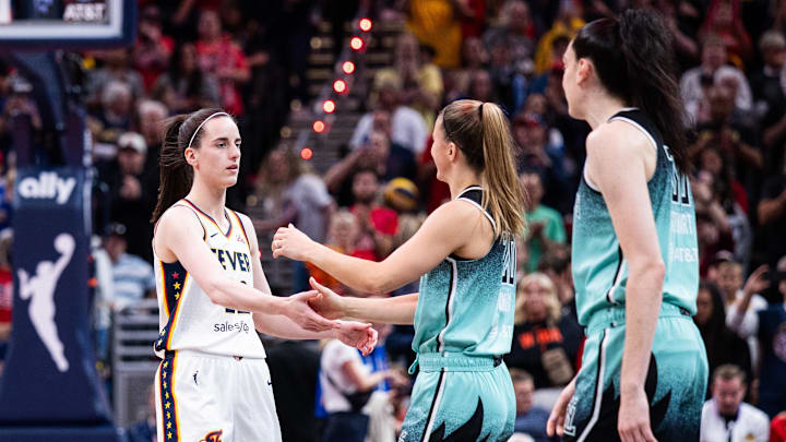 May 24, 2025; Indianapolis, Indiana, USA; Indiana Fever guard Caitlin Clark (22) and New York Liberty guard Sabrina Ionescu (20) before the game at Gainbridge Fieldhouse. Mandatory Credit: Trevor Ruszkowski-Imagn Images