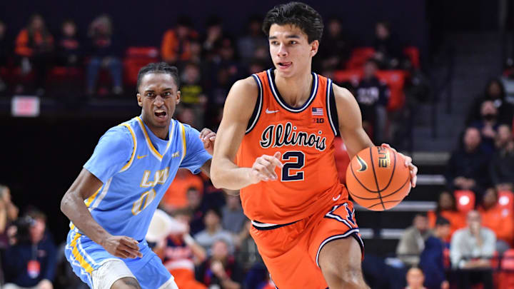 Nov 22, 2025; Champaign, Illinois, USA;  Illinois Fighting Illini guard Andrej Stojakovic (2) drives the ball past Long Island University Sharks guard Greg Gordon (2) during the first half at State Farm Center. Mandatory Credit: Ron Johnson-Imagn Images