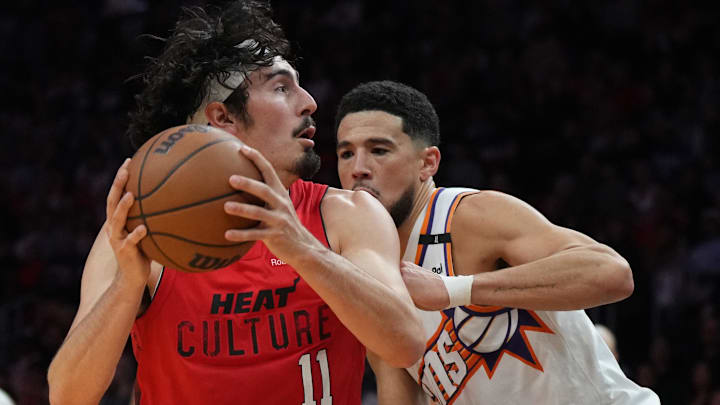 Dec 7, 2024; Miami, Florida, USA;  Miami Heat guard Jaime Jaquez Jr. (11) moves towards the basket agains Phoenix Suns guard Devin Booker (1) during the second half at Kaseya Center. Mandatory Credit: Jim Rassol-Imagn Images