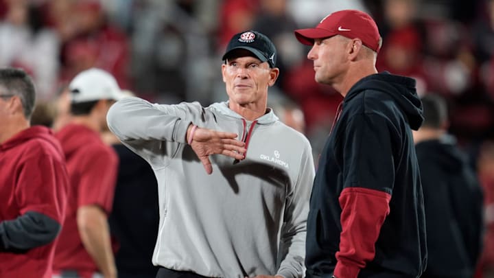 Oklahoma coach Brent Venables talks with Alabama coach Kalen DeBoer 