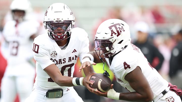 Oct 18, 2025; Fayetteville, Arkansas, USA; Texas A&M Aggies quarterback Marcel Reed (10) and running back Rueben Owens II (4) warm up prior to the game against the Arkansas Razorbacks at Donald W. Reynolds Razorback Stadium. Mandatory Credit: Nelson Chenault-Imagn Images
