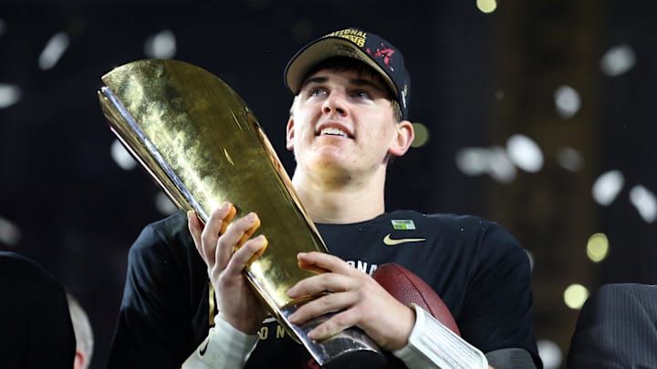 Jan 11, 2016; Glendale, AZ, USA; Alabama Crimson Tide quarterback Jake Coker (14) holds the national championship trophy after defeating the Clemson Tigers  in the 2016 CFP National Championship at University of Phoenix Stadium. Mandatory Credit: Mark J. Rebilas-Imagn Images