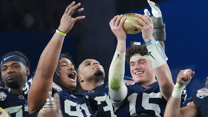 Penn State Nittany Lions teammates Drew Allar (15) and Dvon J-Thomas (91) celebrate their 31-14 win over the Boise State Broncos in the Vrbo Fiesta Bowl at State Farm Stadium. Penn State Nittany Lions teammates Drew Allar (15) and Dvon J-Thomas (91) celebrate their 31-14 win over the Boise State Broncos in the Vrbo Fiesta Bowl at State Farm Stadium.
