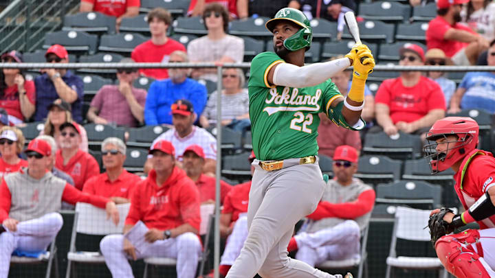 Mar 6, 2024; Tempe, Arizona, USA;  Oakland Athletics right fielder Miguel Andujar (22) hits a three