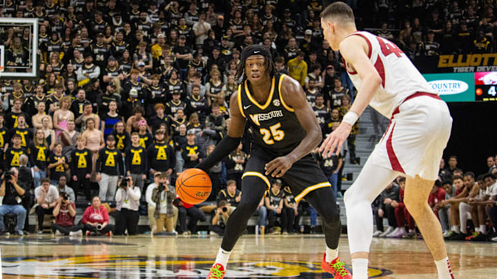 Jan. 18,  2025; Columbia, Missouri, USA; Missouri Tigers forward Mark Mitchell (25) looks to dribble past Zvonimir Ivišić (44) of the Arkansas Razorbacks during a game at Mizzou Arena. 