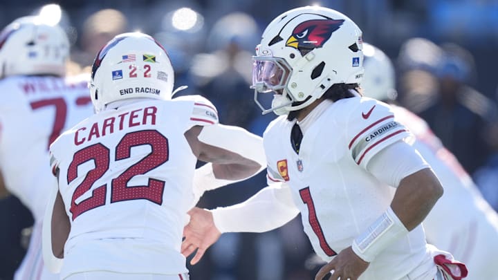 Dec 22, 2024; Charlotte, North Carolina, USA;  Arizona Cardinals quarterback Kyler Murray (1) hands off to running back Michael Carter (22) during the second quarter against the Carolina Panthers at Bank of America Stadium. Mandatory Credit: Jim Dedmon-Imagn Images