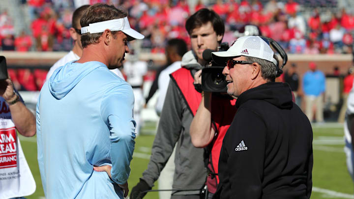 Nov 4, 2023; Oxford, Mississippi, USA; Mississippi Rebels head coach Lane Kiffin (left) and Texas A&M Aggies head coach Jimbo Fisher (right) talk prior to the game at Vaught-Hemingway Stadium. Mandatory Credit: Petre Thomas-Imagn Images