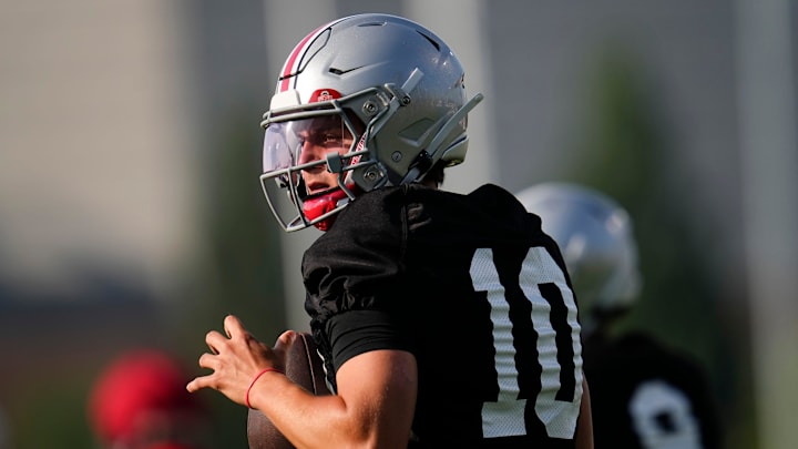 Ohio State Buckeyes quarterback Julian Sayin (10) takes a snap during football training camp at the Woody Hayes Athletic Center on Aug. 1, 2025.