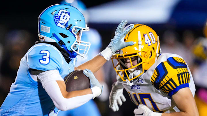 Olentangy Berlin's Colton Less (3) stiff arms Olentangy's Ryan Wiesner (40) in the second half at Olentangy Berlin High School on Oct 25, 2024 in Delaware, Ohio.
