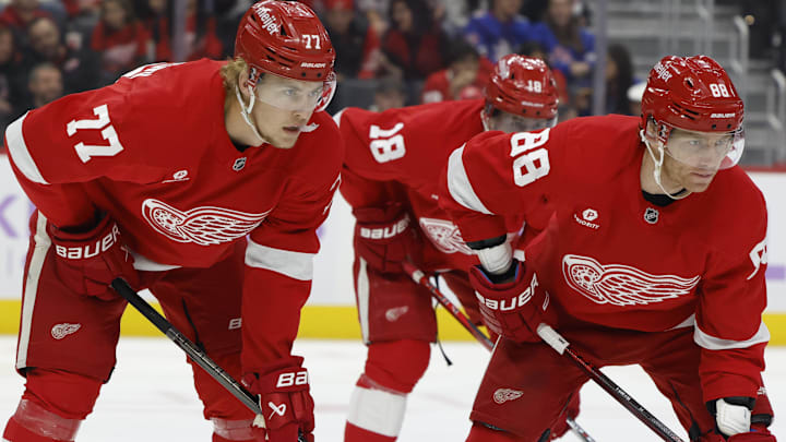Nov 9, 2024; Detroit, Michigan, USA;  Detroit Red Wings defenseman Simon Edvinsson (77) and right wing Patrick Kane (88) get set during a face off against the New York Rangers at Little Caesars Arena. Mandatory Credit: Rick Osentoski-Imagn Images