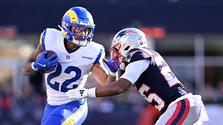 Nov 17, 2024; Foxborough, Massachusetts, USA; Los Angeles Rams running back Blake Corum (22) runs with the ball against New England Patriots cornerback Marcus Jones (25) during the first half at Gillette Stadium. Mandatory Credit: Brian Fluharty-Imagn Images