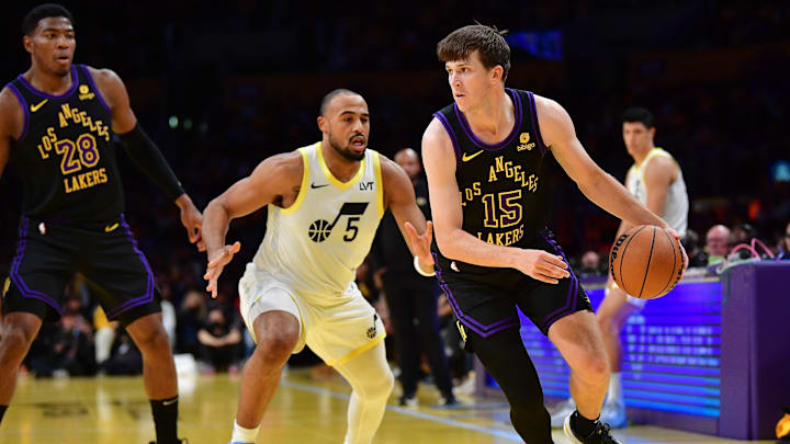 Nov 21, 2023; Los Angeles, California, USA; Los Angeles Lakers guard Austin Reaves (15) moves the ball ahead of Utah Jazz guard Talen Horton-Tucker (5) during the first half at Crypto.com Arena. Mandatory Credit: Gary A. Vasquez-Imagn Images