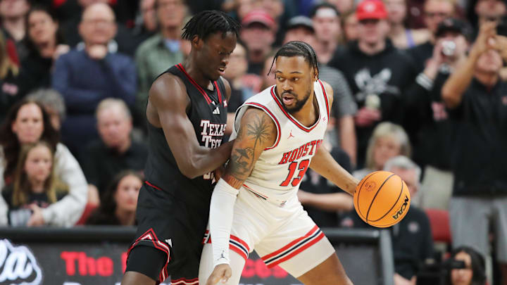 Houston Cougars forward J’Wan Roberts (13) works the ball against Texas Tech Red Raiders foward Fedeiko Federiko (33) in the first half at United Supermarkets Arena. Houston Cougars forward J’Wan Roberts (13) works the ball against Texas Tech Red Raiders foward Fedeiko Federiko (33) in the first half at United Supermarkets Arena.
