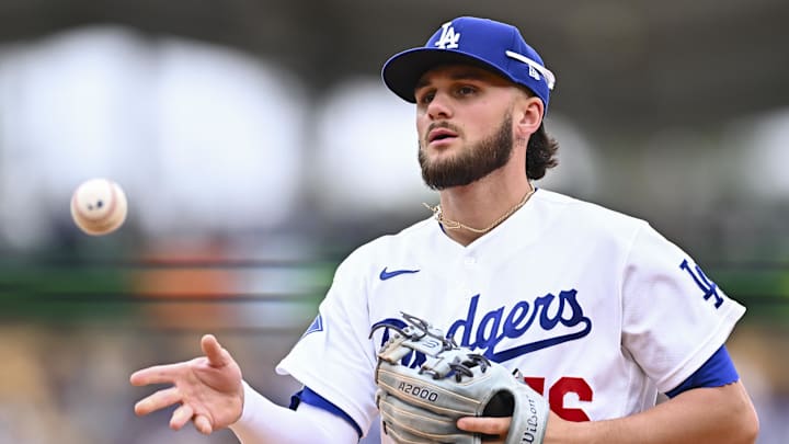 Apr 12, 2026; Los Angeles, California, USA; Los Angeles Dodgers second baseman Alex Freeland (76) tosses the ball to first base to force an out against the Texas Rangers during the fifth inning at Dodger Stadium. Mandatory Credit: Jonathan Hui-Imagn Images