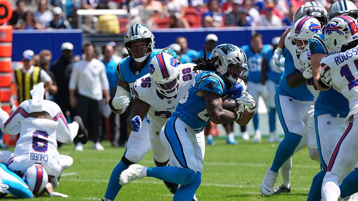 Carolina Panthers running back Jonathon Brooks (25) runs with the ball and is tackled 