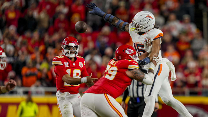 Dec 25, 2025; Kansas City, Missouri, USA; Kansas City Chiefs quarterback Chris Oladokun (19) throws against Denver Broncos linebacker Nik Bonitto (15) during the fourth quarter at GEHA Field at Arrowhead Stadium. 