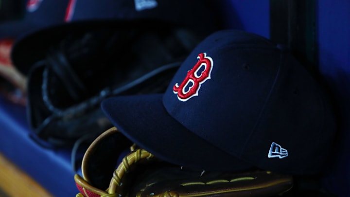 Jul 22, 2019; St. Petersburg, FL, USA; A detail view of Boston Red Sox hat and glove laying in the dugout at Tropicana Field. Mandatory Credit: Kim Klement-Imagn Images