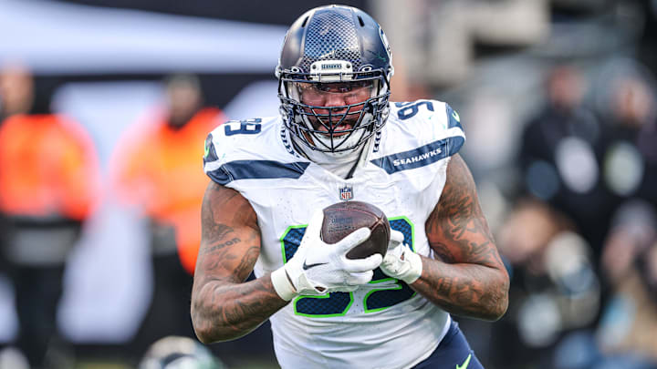 Dec 1, 2024; East Rutherford, New Jersey, USA; Seattle Seahawks defensive end Leonard Williams (99) intercepts a pass for a touchdown during the first half against the New York Jets at MetLife Stadium. Mandatory Credit: Vincent Carchietta-Imagn Images