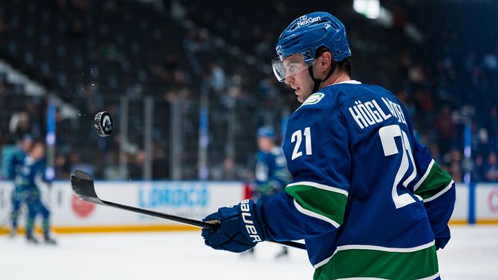 Apr 14, 2026; Vancouver, British Columbia, CAN; Vancouver Canucks forward Nils Hoglander (21) handles the puck in warm up prior to a game against the Los Angeles Kings at Rogers Arena. Mandatory Credit: Bob Frid-Imagn Images