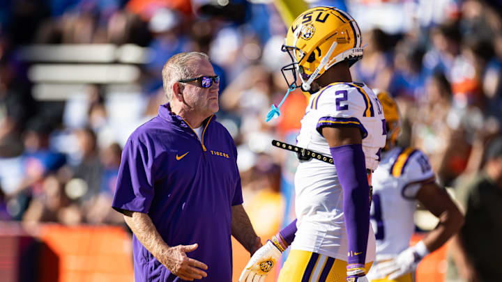 Nov 16, 2024; Gainesville, Florida, USA; LSU Tigers head coach Brian Kelly talks with LSU Tigers wide receiver Kyren Lacy (2) before a game against the Florida Gators at Ben Hill Griffin Stadium. Mandatory Credit: Matt Pendleton-Imagn Images