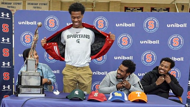 Stepinac High School basketball star Jasiah Jervis unveils a Michigan State University t-shirt as he announces which college he will be attending and playing basketball at during a ceremony at Stepinac High School in White Plains Nov. 5, 2025. With Jasiah was his mother Falana, his father Rhodes, and brother Jafari.