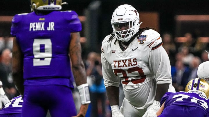 Texas Longhorns defensive lineman T'Vondre Sweat (93) watches Washington quarterback Michael Penix Jr. (9) before a snap during the Sugar Bowl College Football Playoff semifinals game at the Caesars Superdome on Monday, Jan. 1, 2024 in New Orleans, Louisiana. Texas Longhorns defensive lineman T'Vondre Sweat (93) watches Washington quarterback Michael Penix Jr. (9) before a snap during the Sugar Bowl College Football Playoff semifinals game at the Caesars Superdome on Monday, Jan. 1, 2024 in New Orleans, Louisiana.
