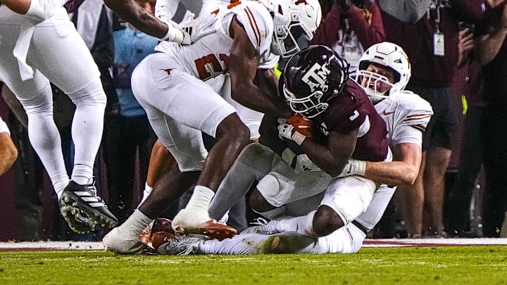 Nov 30, 2024; College Station, Texas, USA; Texas longhorns edge rusher Ethan Burke (91) stops Texas A&M running back Amari Daniels (5) on fourth and goal at the 1-yard line during the Lone Star Showdown at Kyle Field. Mandatory Credit: Sara Diggins/USA TODAY Network via Imagn Images