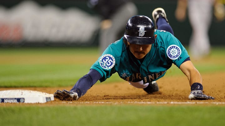 Seattle Mariners second baseman Munenori Kawasaki slides to first base against the Baltimore Orioles on July 2, 2012, at Safeco Field.