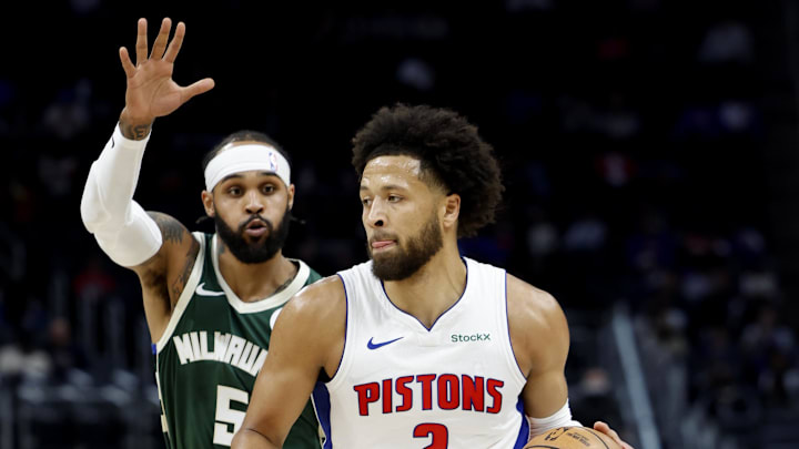 Detroit Pistons guard Cade Cunningham dribbles on Milwaukee Bucks guard Gary Trent Jr. in the first half at Little Caesars Arena on Sunday.