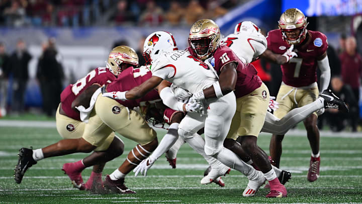Dec 2, 2023; Charlotte, NC, USA; Louisville Cardinals wide receiver Kevin Coleman (3) is tackled by Florida State Seminoles linebacker DJ Lundy (10) in the first quarter at Bank of America Stadium. Mandatory Credit: Bob Donnan-Imagn Images