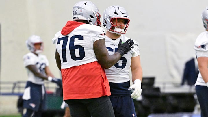 Jun 10, 2025; Foxborough, MA, USA; New England Patriots offensive tackle Morgan Moses (76) and New England Patriots center Garrett Bradbury (65) react after completing a drill during minicamp held in the WIN Field House at Gillette Stadium. Mandatory Credit: Eric Canha-Imagn Images