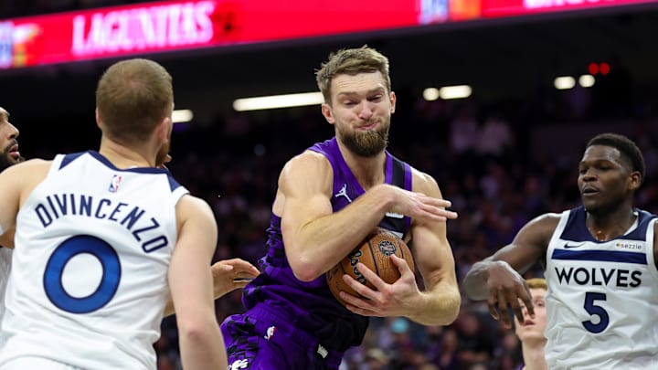 Nov 15, 2024; Sacramento, California, USA; Sacramento Kings forward Domantas Sabonis (11) grabs a rebound against Minnesota Timberwolves guard Anthony Edwards (5) during the third quarter at Golden 1 Center. Mandatory Credit: Sergio Estrada-Imagn Images