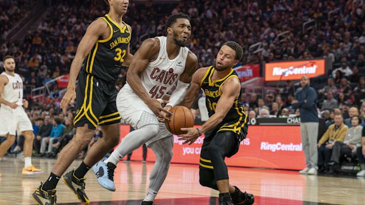 Nov 11, 2023; San Francisco, California, USA;  Golden State Warriors guard Stephen Curry (30) steals the basketball from Cleveland Cavaliers guard Donovan Mitchell (45) during the second quarter at Chase Center. Mandatory Credit: Neville E. Guard-Imagn Images