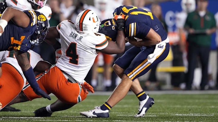 Oct 5, 2024; Berkeley, California, USA; Miami Hurricanes defensive lineman Rueben Bain Jr. (4) sacks California Golden Bears quarterback Fernando Mendoza (right) during the fourth quarter at California Memorial Stadium. Mandatory Credit: Darren Yamashita-Imagn Images