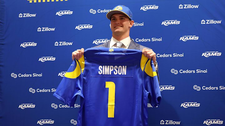 Los Angeles Rams first-round draft pick Ty Simpson poses with his jersey during a press conference at Code Next at Hollywood Park. Mandatory Credit: Kiyoshi Mio-Imagn Images