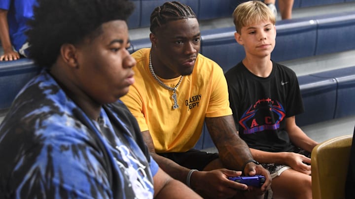 Alabama quarterback Jalen Milroe plays the new EA Sports College Football 25 video game at the McDonald Hughes Center in Tuscaloosa. Milroe is one of the players featured on the game’s cover.