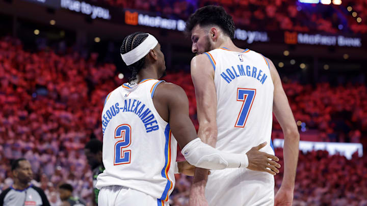 May 20, 2025; Oklahoma City, Oklahoma, USA; Oklahoma City Thunder guard Shai Gilgeous-Alexander (2) and forward Chet Holmgren (7) react after a play in the fourth quarter against the Minnesota Timberwolves during game one of the western conference finals for the 2025 NBA Playoffs at Paycom Center. Mandatory Credit: Alonzo Adams-Imagn Images