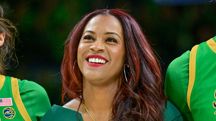 Mar 2, 2025; South Bend, Indiana, USA; Notre Dame Fighting Irish head coach Niele Ivey smiles as she stands with her players for the Notre Dame Alma Mater after defeating the Louisville Cardinals 72-59 at the Purcell Pavilion. 