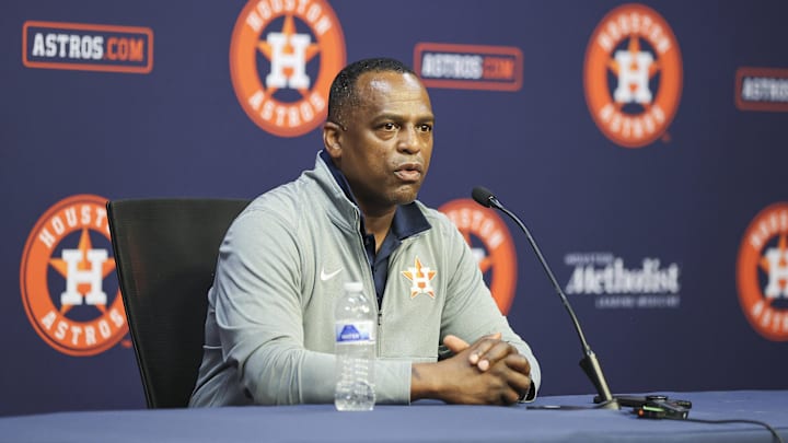 Houston Astros general manager Dana Brown speaks with media with an Astros logo backdrop behind him Houston Astros general manager Dana Brown speaks with media with an Astros logo backdrop behind him