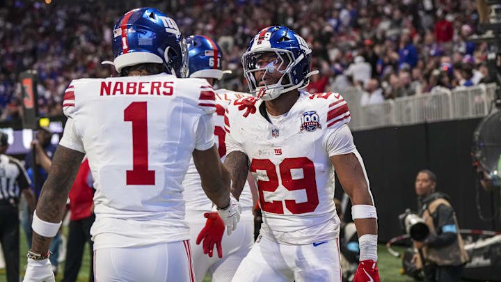Dec 22, 2024; Atlanta, Georgia, USA; New York Giants running back Tyrone Tracy Jr. (29) reacts with wide receiver Malik Nabers (1) after catching a touchdown pass against the Atlanta Falcons during the first half at Mercedes-Benz Stadium.  