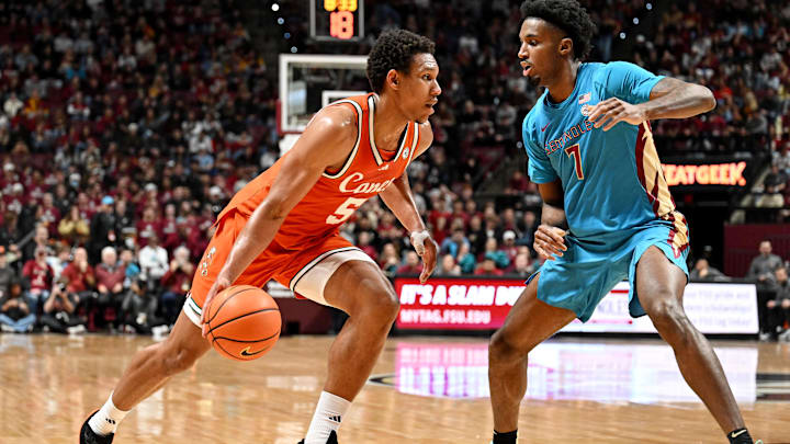 Feb 24, 2026; Tallahassee, Florida, USA; Miami Hurricanes forward Malik Reneau (5) drives to the net past Florida State Seminoles forward Chauncey Wiggins (7) during the first half at Donald L. Tucker Center. Mandatory Credit: Melina Myers-Imagn Images Feb 24, 2026; Tallahassee, Florida, USA; Miami Hurricanes forward Malik Reneau (5) drives to the net past Florida State Seminoles forward Chauncey Wiggins (7) during the first half at Donald L. Tucker Center. Mandatory Credit: Melina Myers-Imagn Images