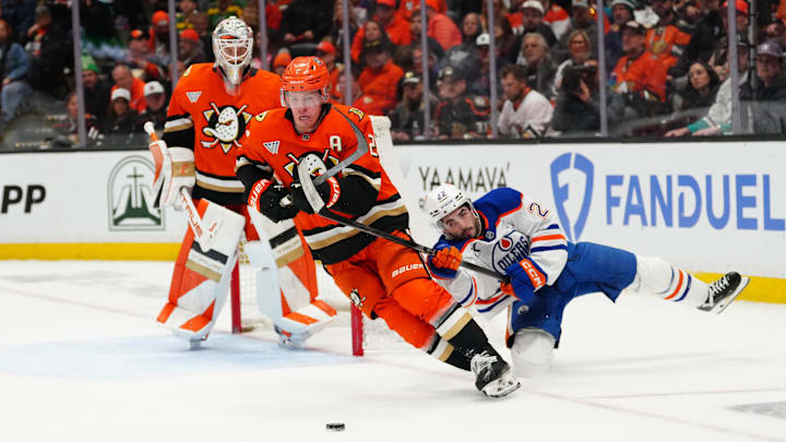 Apr 30, 2026; Anaheim, California, USA; Anaheim Ducks defenseman Jackson LaCombe (2) skates with the puck against Edmonton Oilers center Matt Savoie (22) in the first period of game six of the first round of the 2026 Stanley Cup Playoffs at Honda Center. Mandatory Credit: Kirby Lee-Imagn Images