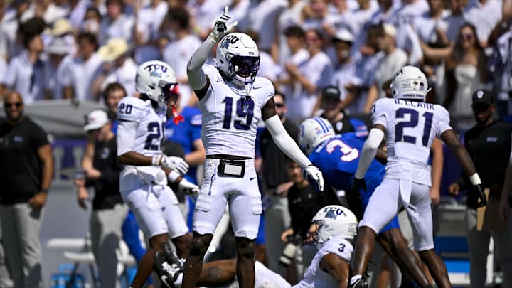 Sep 20, 2025; Fort Worth, Texas, USA; TCU Horned Frogs safety Kylin Jackson (19) and cornerback Jevon McIver Jr. (20) and safety Bud Clark (21) celebrate a defensive stop against the SMU Mustangs during the first half at Amon G. Carter Stadium. Mandatory Credit: Jerome Miron-Imagn Images