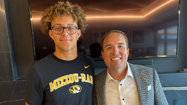 Westside quarterback Braylen Warren stands with Missouri Tigers head coach Eli Drinwkitz. 